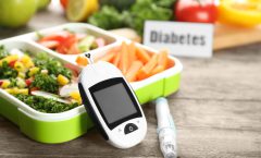 digital-glucometer-lancet-pen-lunch-box-with-vegetables-table-diabetes-diet